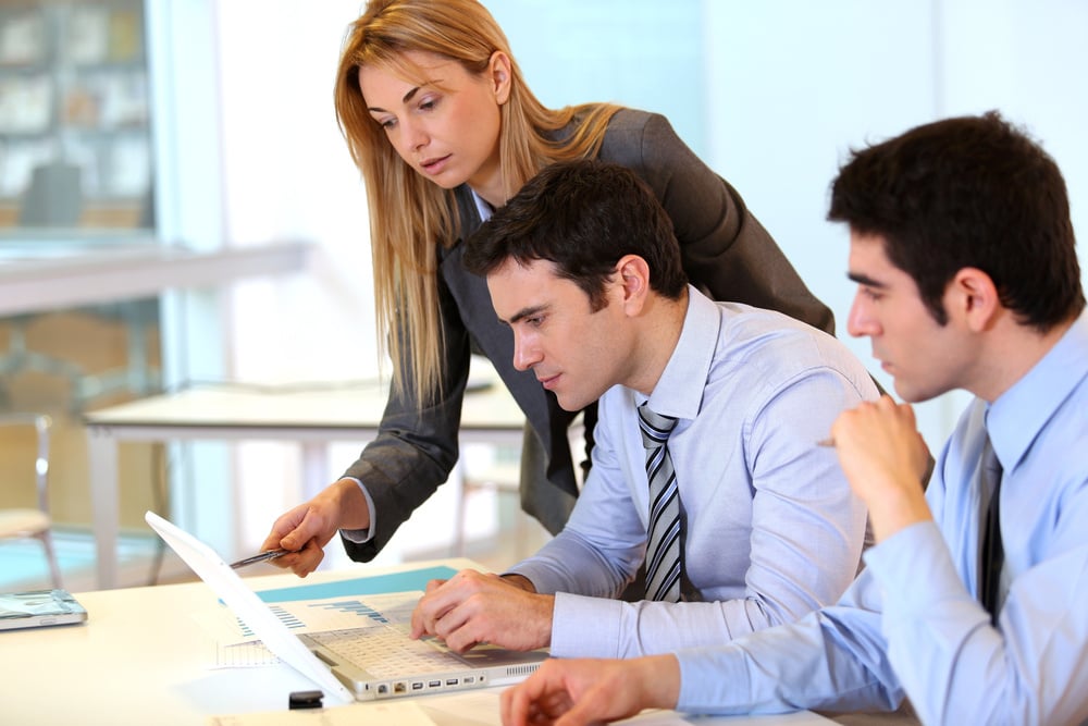 business people reviewing their financials on a computer