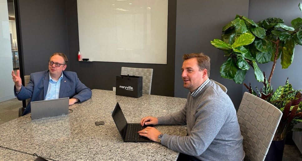 Jeff Blomker and Dr Alexander Becker in a meeting room