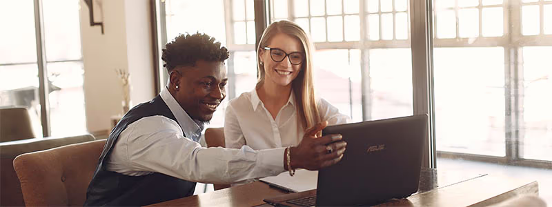 two-people-working-laptop-smiling-1