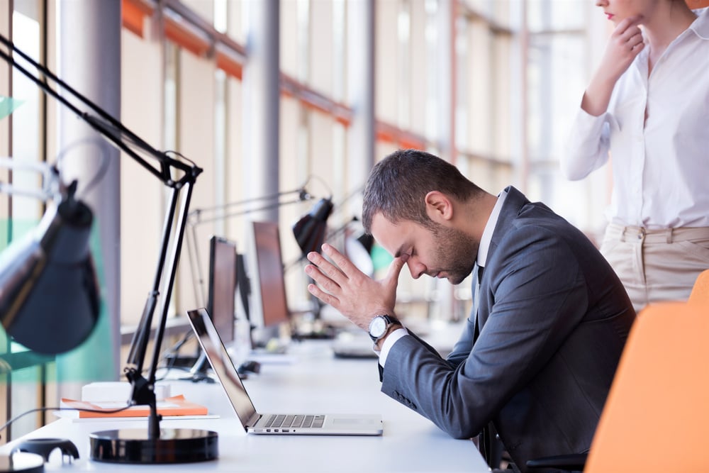 Man has a headache from using Excel