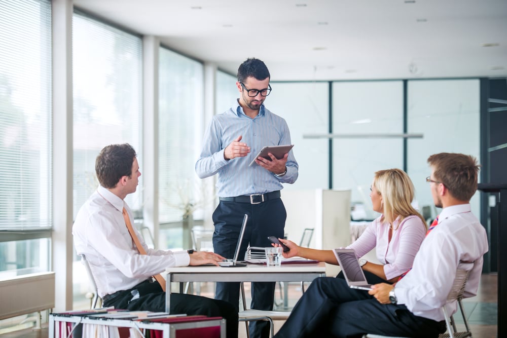 Business people in office checking for hidden IT costs